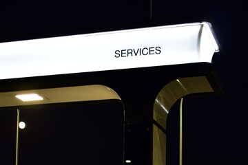 Neon sign - SERVICES - on dark night background