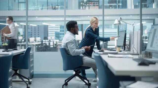 Diverse Team of Managers Working and Having Discussions in Modern Big City Office. Colleagues Talk About New Business Opportunities, Evaluate Financial Reports, Plan Investment Strategy.
