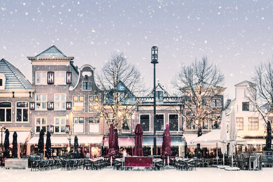 Winter snow view of the famous Dutch Waagplein with pubs and restaurants in Alkmaar, The Netherlands