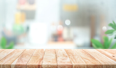 Wood table top on blur kitchen counter background.