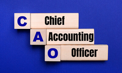 On a bright blue background, light wooden blocks and cubes with the text CAO Chief Accounting Officer
