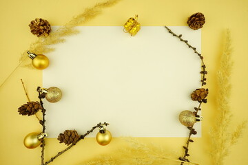  Christmas ( Xmas) composition on yellow background. Frame made of New Year holiday decorations. Top view, copy space, flat lay.