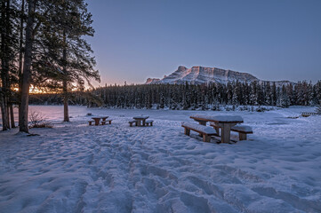 Sunrise on picnic tables and Mount Rundle at Johnson Lake in Banff National Park, Alberta, Canada