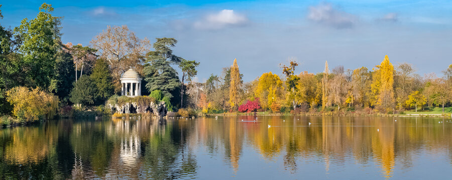 Vincennes, the temple of love and artificial grotto on the Daumesnil lake, in the public park, in autumn
