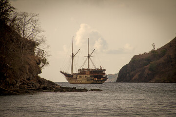 A phinisi boat departs from the port of Labuan Bajo, carrying tourists who will visit the islands around the waters of Labuan Bajo, East Nusa Tenggara, Indonesia.