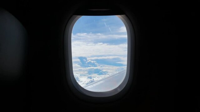 View from in side plane cabin through plane window while storm raining outside