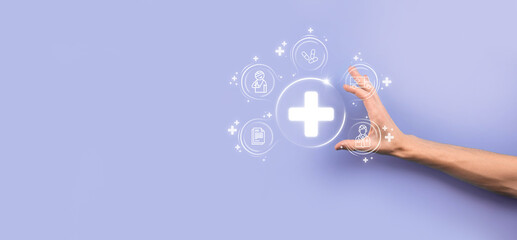 Businessman hold virtual plus medical network connection icons. Covid-19 pandemic develop people awareness and spread attention on their healthcare.Doctor,document,medicine,ambulance,patient icon.