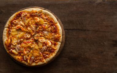 Pizza placed on a wooden tray.