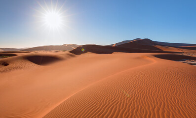 Obraz na płótnie Canvas Big orange sand dune with blue sky - Sossusvlei, Namib desert, Namibia, Southern Africa