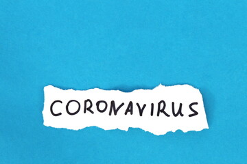 Coronavirus is written on white paper on a blue background.