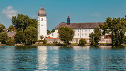 Fototapeta na wymiar Beautiful church with reflections in the lake at the famous Fraueninsel, Chiemsee, Bavaria, Germany