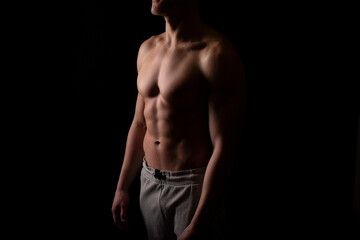 Fototapeta na wymiar Man Showing ABS. Muscle man Posing. Strong Body Concept. Topless Sport man Bodybuilder. Six Pack Spotsman