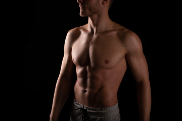 Fototapeta premium Man Showing ABS. Muscle man Posing. Strong Body Concept. Topless Sport man Bodybuilder. Six Pack Spotsman