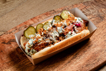 fast food hot dog with smoked minced meat and pickled cucumbers