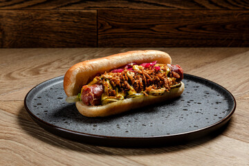 fast food hot dog with homemade sausage, deep-fried onions and pickled cucumbers