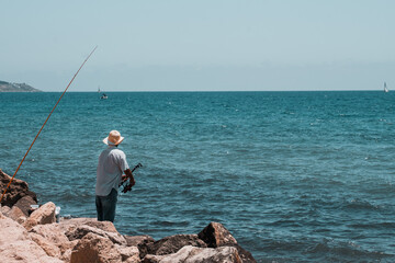 Fototapeta na wymiar spanish fisherman in alicante waiting in the mediterranean sea spain