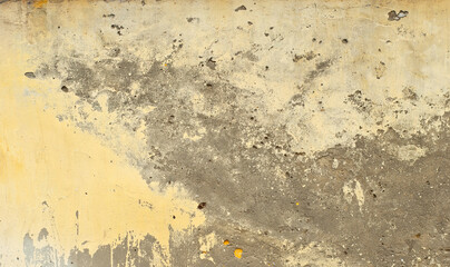 Plaster on a yellow wall. Concrete wall texture close up.