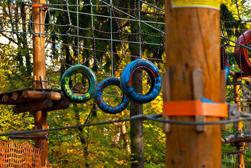 Rope park for children. Extreme outdoor entertainment. Slings, ropes and wires are tied to trees.