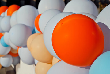The entrance to the store is decorated with colorful balls. Multicolored balloons close up. Festive opening.