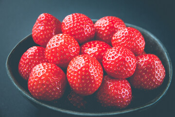 Strawberries in a bowl. Black background