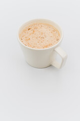delicious hot vegan Cappuccino with foam in a white stoneware cup on a white background