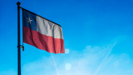 Chile national flag on flagpole waving on the sky with beautiful sun light. Diplomacy concept.