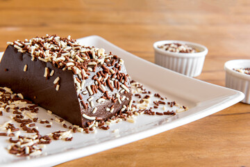 Details of Chocolate pudding with sprinkles, delicious chocolate dessert on wooden table