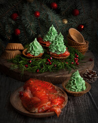 Christmas appetizer dish. Tartlets with salmon and cream cheese. Christmas food. Selective focus - 469967245