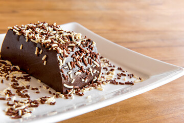 Details of Chocolate pudding with sprinkles, delicious chocolate dessert on wooden table