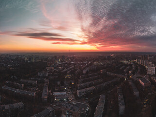 Aerial scenic vivid colorful sunset view with epic skyscape. Kharkiv city center, Pavlove pole residential district streets in evening light. Color graded wide panorama view