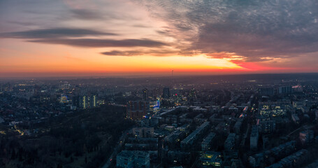 Obraz premium Aerial scenic vivid sunset view with dramatic skyscape panorama. Kharkiv city center, Pavlove pole residential district streets in blue evening light