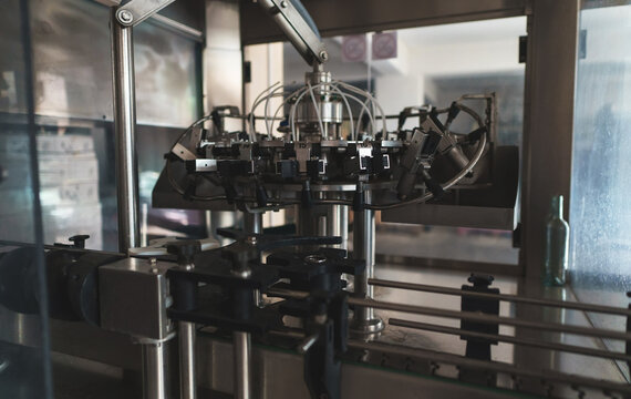 Automatic monoblock wine filling machine at wine factory.