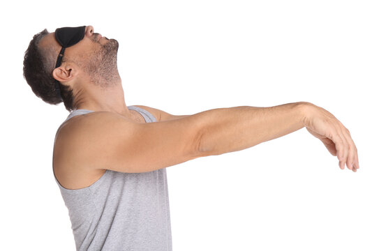 Man with eye mask in sleepwalking state on white background