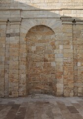 The niche is made in an old building of a rounded shape.	