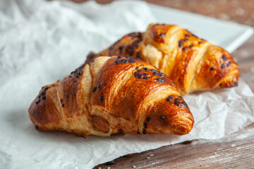 Fresh Baked Croissants on wood background.