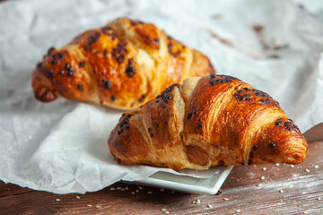Fresh Baked Croissants on wood background.