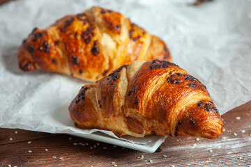 Fresh Baked Croissants on wood background.