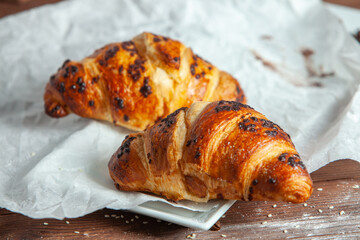 Fresh Baked Croissants on wood background.