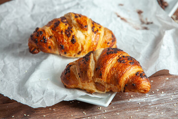 Fresh Baked Croissants on wood background.