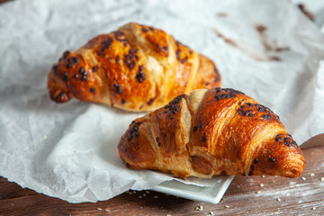 Fresh Baked Croissants on wood background.