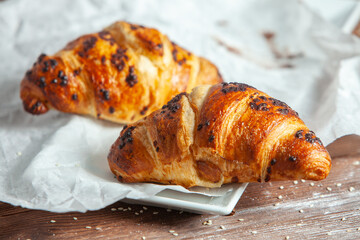 Fresh Baked Croissants on wood background.