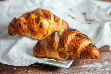 Fresh Baked Croissants on wood background.