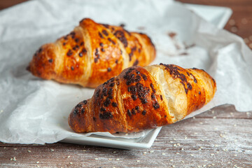 Fresh Baked Croissants on wood background.