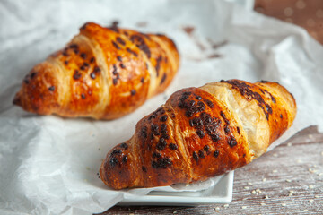 Fresh Baked Croissants on wood background.