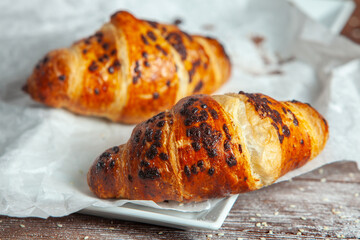 Fresh Baked Croissants on wood background.