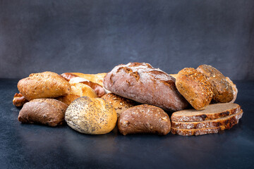 Delicious freshly baked bread on a rustic background. Front view, copy space