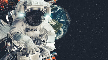 Astronaut spaceman do spacewalk while working for spaceflight mission at space station . Astronaut wear full spacesuit for operation . Elements of this image furnished by NASA space astronaut photos . © InfiniteFlow