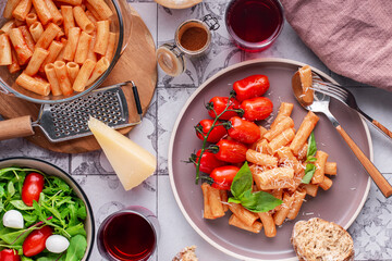 pasta with tomatoes. basil and grated parmesan