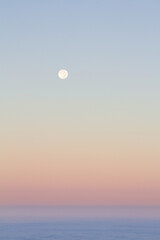 Moonrise over a blanket of clouds
