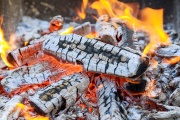 Firewood burning on grill. Burning fire, flame of fire close-up, burning firewood.